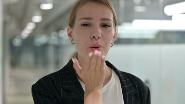 Portrait of Loving Businesswoman Giving Flying Kiss