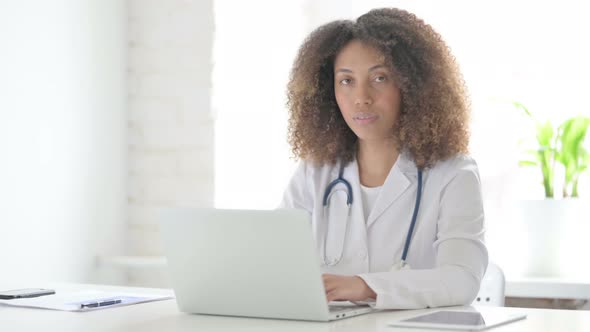 Afrcian Doctor Showing Thumbs Up While using Laptop in Clinic