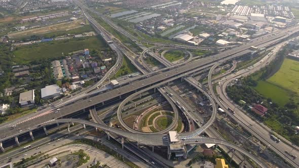 Aerial View of Highway Road Interchange with Busy Urban Traffic Speeding on Road