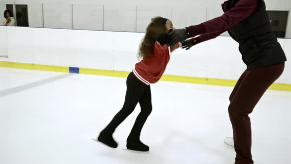 Female Coach Training Little Girl for Figure Skating