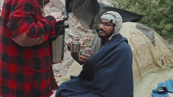 Refugee Man Drinking Hot Tea Outside Tent