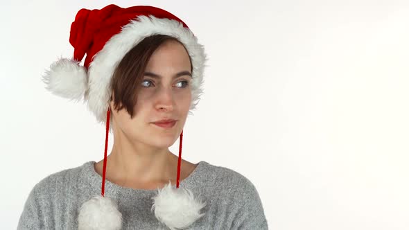 Young Beautiful Woman in Christmas Hat Looking Surprised or Shocked