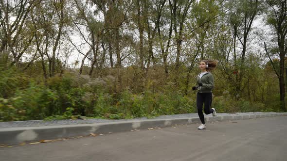 Slow Motion Jogger on Autumn Day