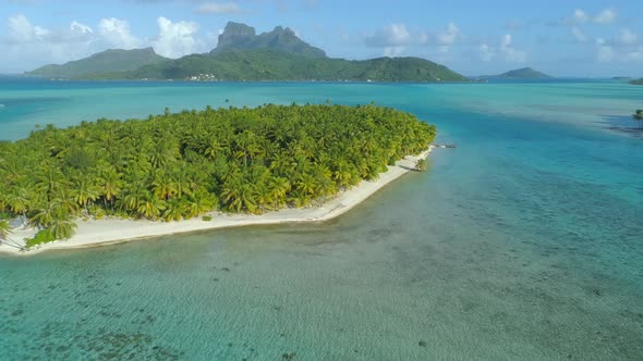 Aerial drone view of a deserted island near Bora Bora tropical island.