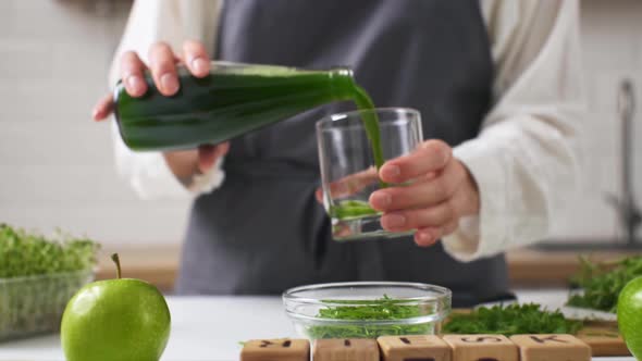 The Cook Pours Fresh Juice Into A Glass. Close Up Pouring Green Juice Into A Glass. Detox