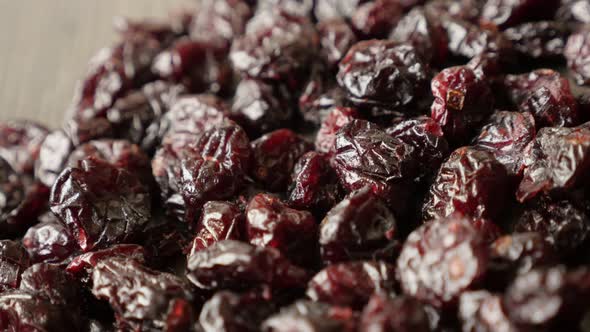 Pile of dehydrated red cranberries on table slow pan 4K 2160p 30fps UltraHD  footage - Shallow DOF V