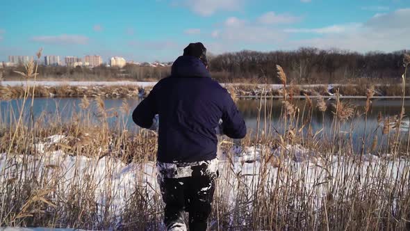 Guy Stuntman Does Cool Trick Jump Over Bushes in Snowdrift