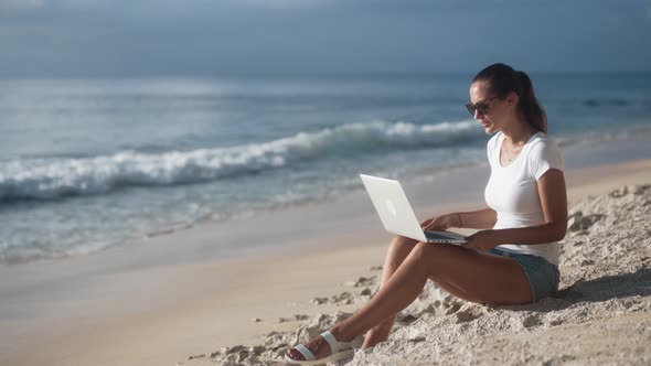 Charming Young Woman in Sunglasses Is Talking Via Video Communication