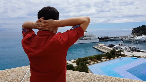 Successful Man Observing Yachts From Terrace of Luxury Hotel, Expensive Resort