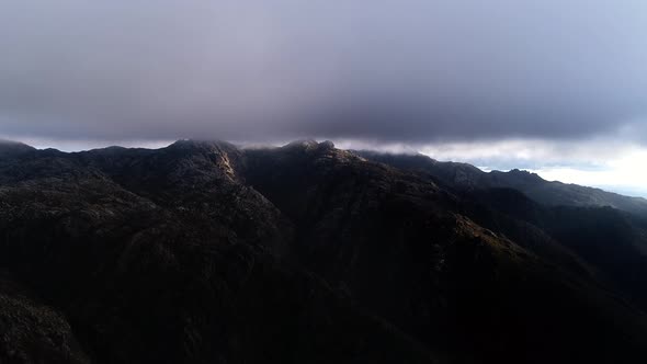 Fly Through the Clouds Over the Mountain Peaks