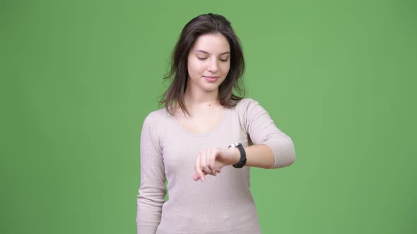 Young Happy Beautiful Woman Thinking While Checking Time