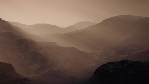 Black Rocky Mountain Silhouette in Deep Fog