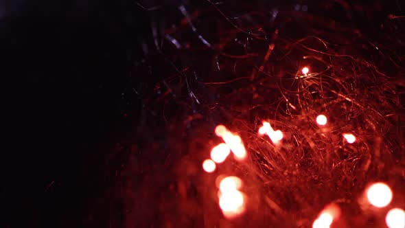 Macro of steel wool burning as fire moves through fibers.