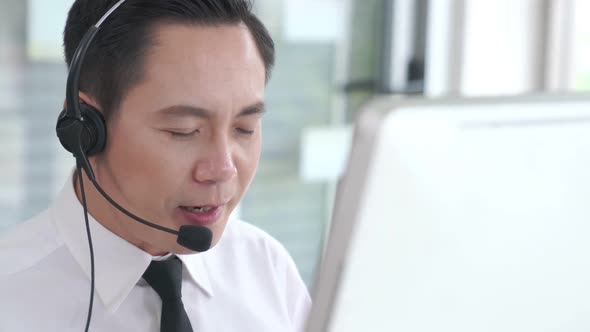 Businessman Wearing Headset Working Actively in Office