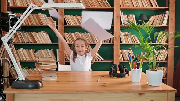 The Teenage Girl is Studying in the Library Throws a Piece of Paper in the Air and Rejoices Children