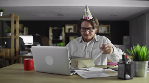 Alone Businessman Is Opening Gift on Birthday in the Office