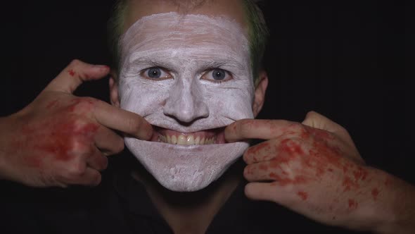 Clown Halloween Man Portrait. Close-up of an Evil Clowns Face. White Face Makeup