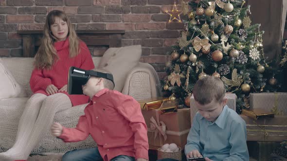 Blond Haired Mom Enjoys Children Playing with Presents