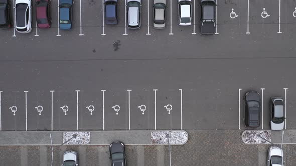 Halffilled Car Park with Places for Disabled Persons Near Supermarket  Aerial Top View Footage