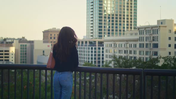 Attractive Woman Look Around Standing on Cityscape