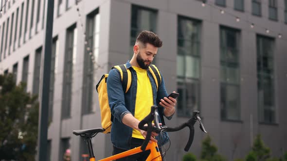 The Food Delivery Guy is Standing and Texting