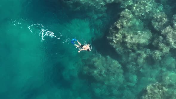 Beautiful Aerial Shot of Male Guy Snorkeling in Mask and Flippers at Coral Reef