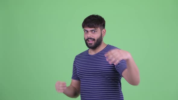 Happy Young Overweight Bearded Indian Man with Surprise Gesture