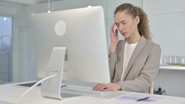 Tired Young Businesswoman Having Headache in Office