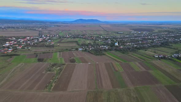 Drone Aerial View of Autumn Fields with Countryside Farmland Huts Around the Little Village