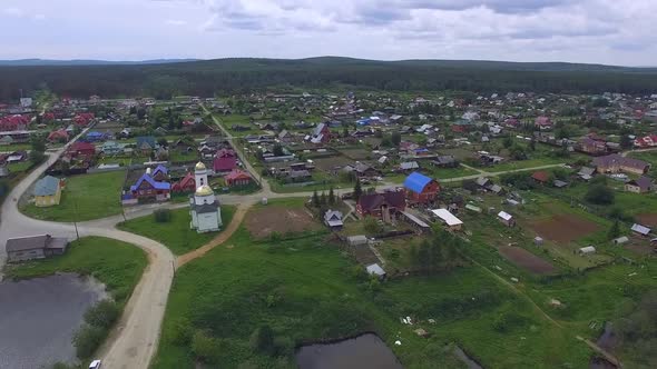 Aerial view of village with a church by the pond. 03