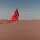 An Asian Woman in a Red Dress Dancing on Sand Dunes - VideoHive Item for Sale
