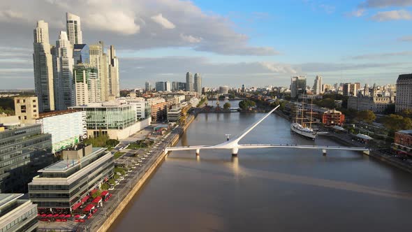 Cinematic aerial pull out view of Woman's Bridge in Puerto Madero, Buenos Aires