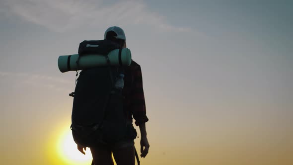 Woman Traveler with Backpack Exploring on Top of Mountains