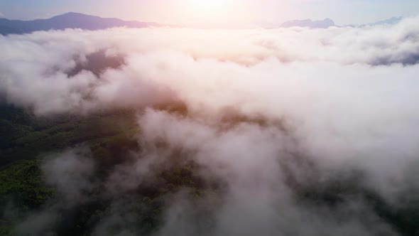 Drone flying above the clouds during sunrise