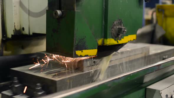 Work of an Industrial Surface Grinding Machine. Grinding of a Flat Metal Part.