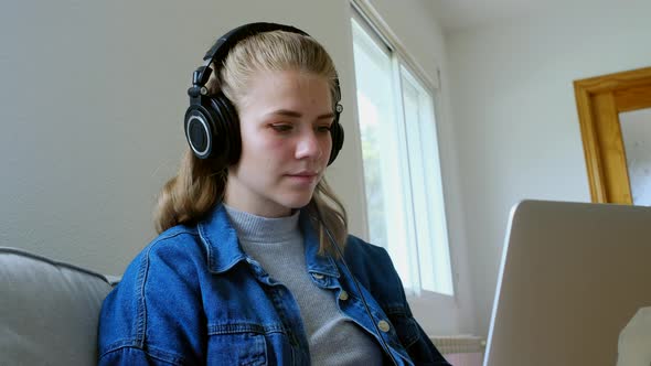 Modern woman working with laptop at home