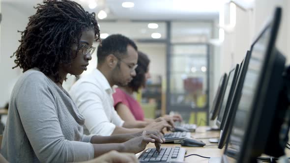 Students Passing Exams By Computers in Class