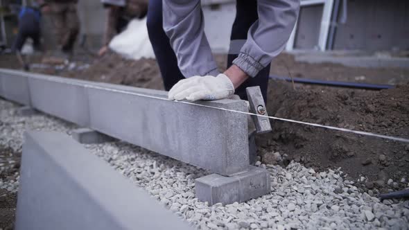 footage of builder installs curb