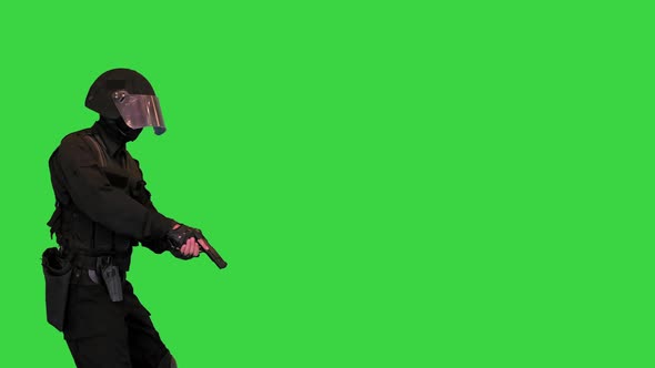 Police SWAT Armed Fighter Walking with a Hand Gun on a Green Screen Chroma Key
