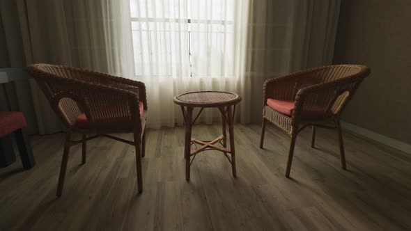 Two Empty Chairs and Table Near the Window