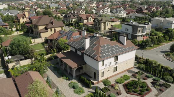 Establishing Shot of Cottage Township with Solar Photovoltaic Panels Arrays on the Roofs