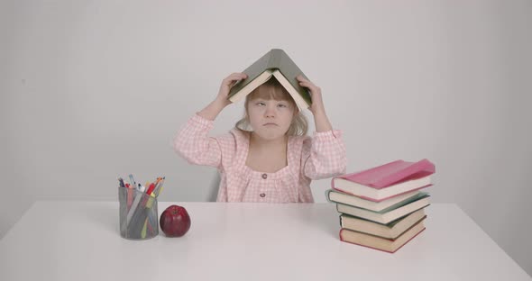 A Girl with Down Syndrom Playing with Book