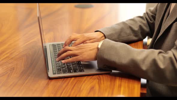 Male african american user hands typing on laptop keyboard sit at table, mixed race ethnic