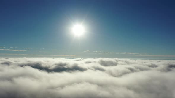 Above the clouds. Sunrise foggy morning.