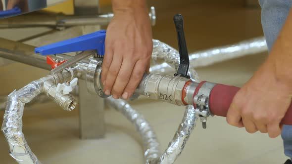 Crop View of Manufacture Worker Setting Correctly Pipes of Beer Boilers