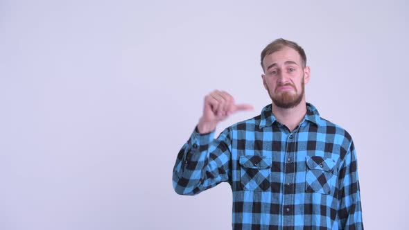 Sad Bearded Hipster Man Pointing Up and Giving Thumbs Down