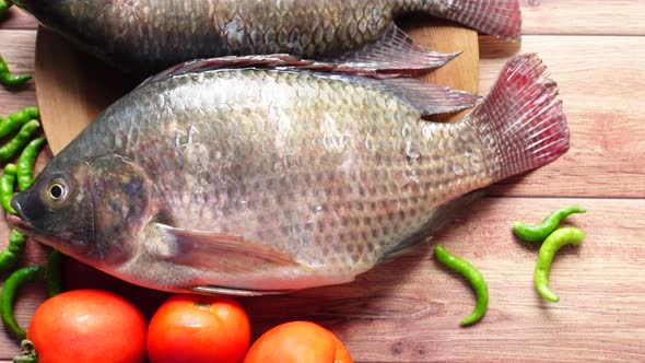 Raw Fresh Fish on a Chopping Board for Preparing for Cooking on Table 