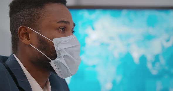 Side View of African Office Worker Wearing Protective Mask After Catching Cold