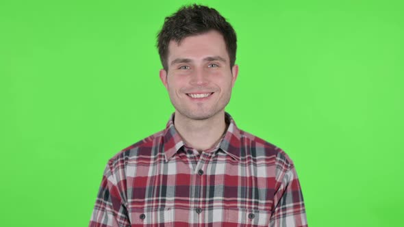 Portrait of Young Man Smiling at Camera Green Chroma Screen