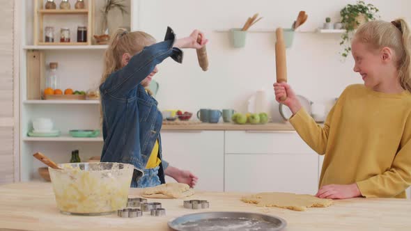 Twin Sisters Fighting with Rolling Pins